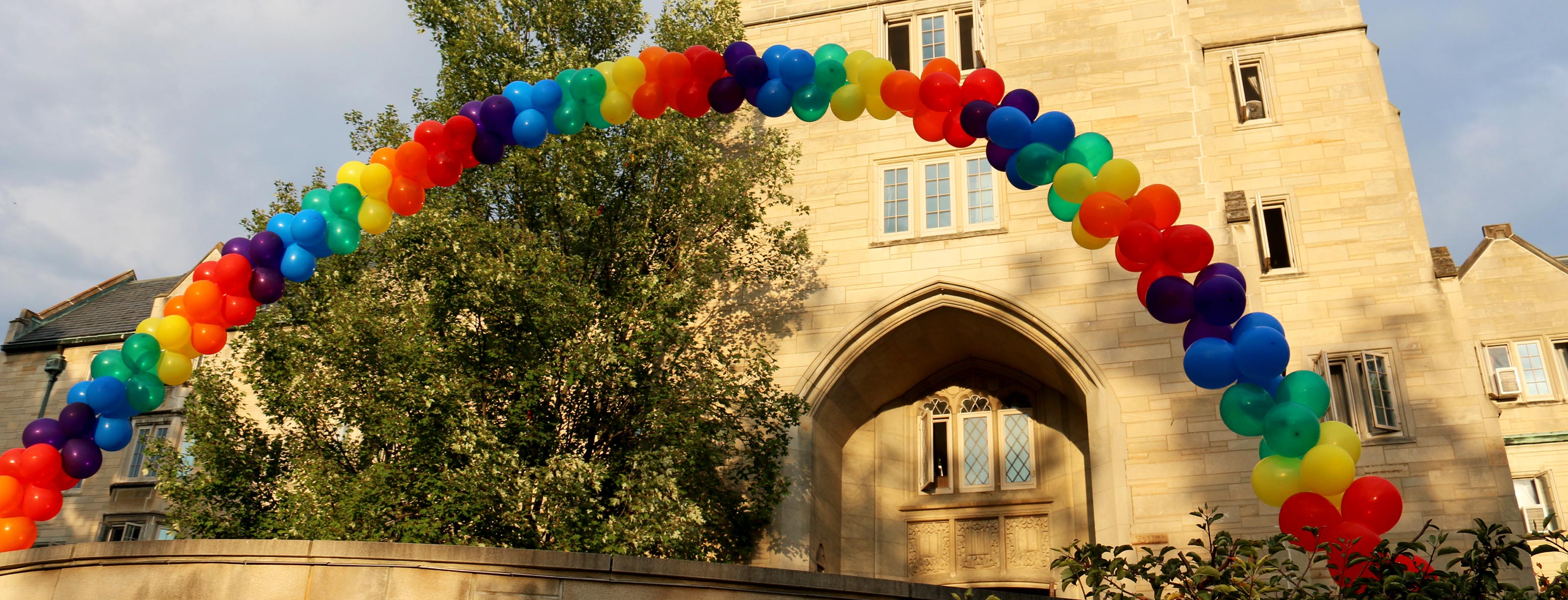 Massive rainbow balloon arch in front of the entrance to the Collins Center