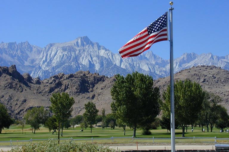 American flag flying in front of the Sierra Nevada mountain range