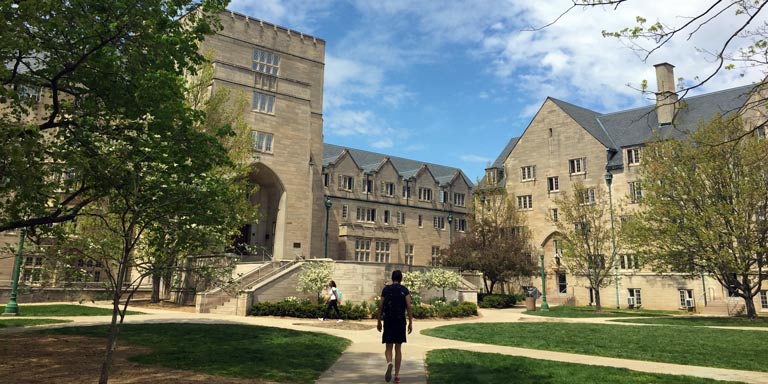 Student walking through the Collins Center courtyard