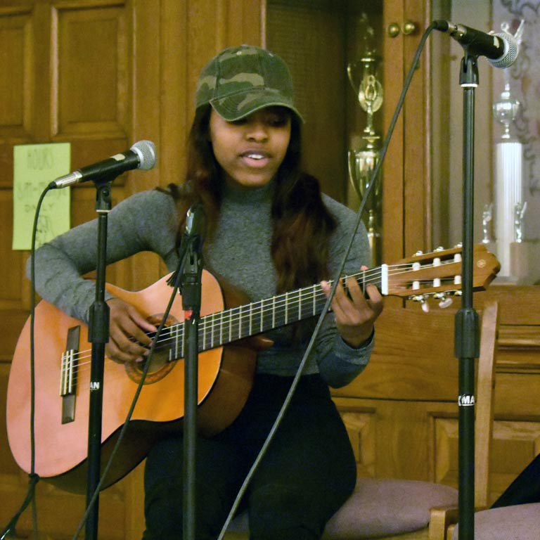 Student playing the guitar and singing